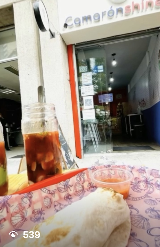 Reel still: a drink on the terrace table in front of the facade with the Camarónshine sign, 539 views