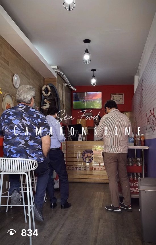 Reel still: customers at the counter, with the logo on the front of the bar, 834 views
